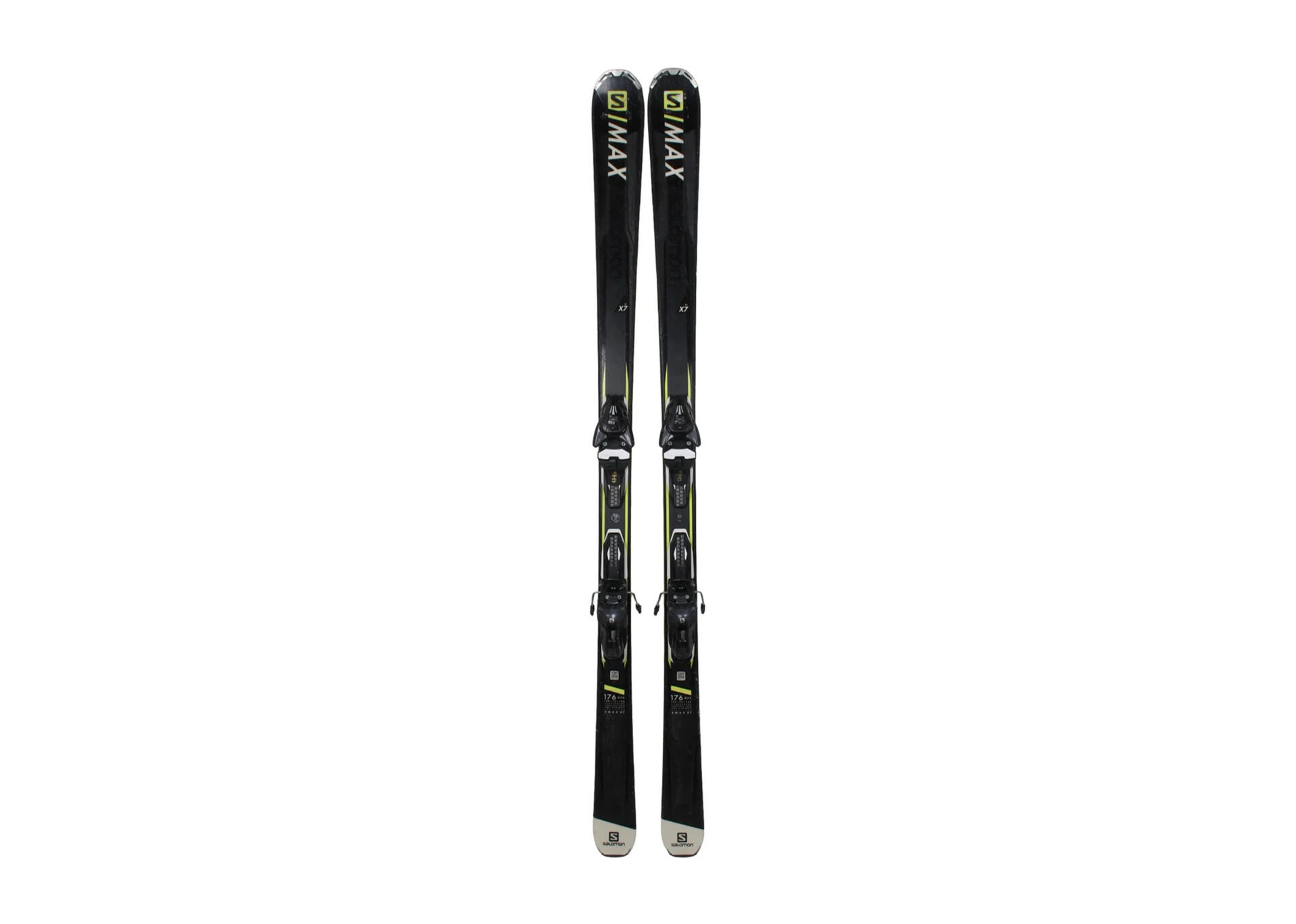 A pair of black skis with white and yellow accents, labeled “S/MAX,” stand upright against a plain white background, conveying an elegant, modern design.