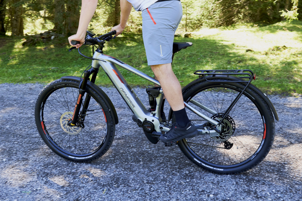 Close-up of a gray Genesis brand e-mountain bike with full suspension