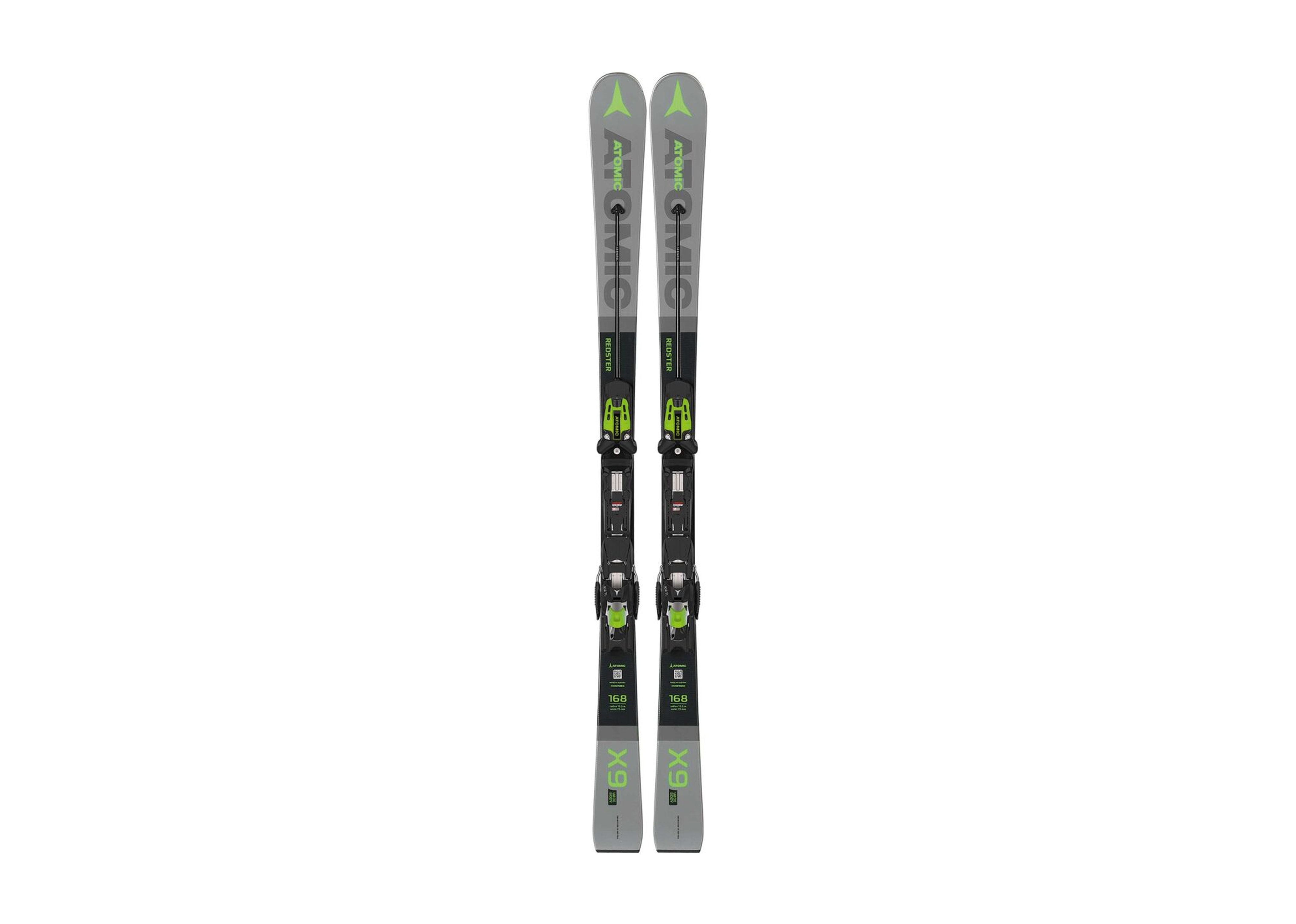 Ein Paar schlanke, grau-schwarze Ski mit grünen Akzenten und Bindungen stehen aufrecht auf einem weißen Hintergrund und präsentieren ein modernes, sportliches Design.